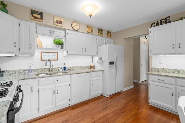 1088 Alameda Dr, Aurora, IL 60506 - kitchen with white appliances, white cabinetry, tasteful backsplash, wood finished floors, and light stone countertops