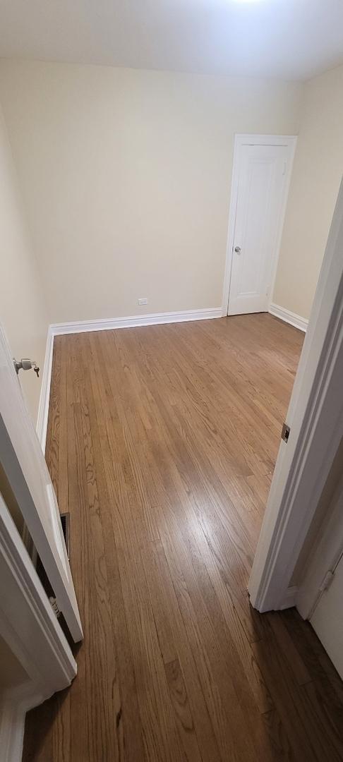empty room with baseboards and wood finished floors