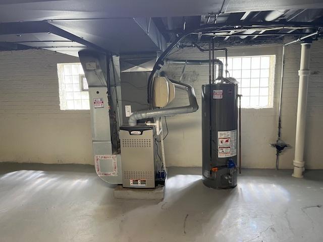 utilities featuring water heater and heating unit