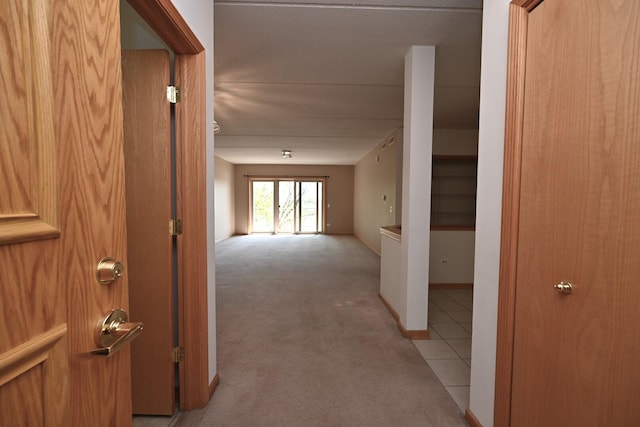 corridor with light colored carpet and baseboards