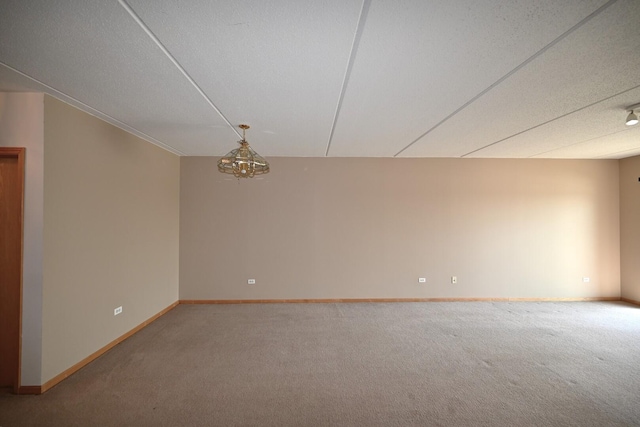 carpeted spare room with baseboards