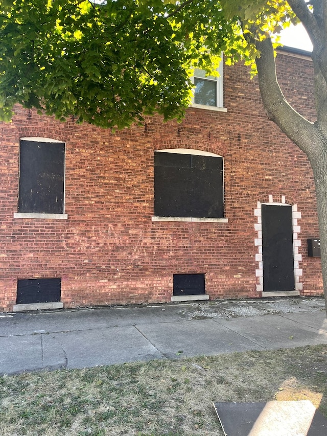 view of side of property featuring brick siding