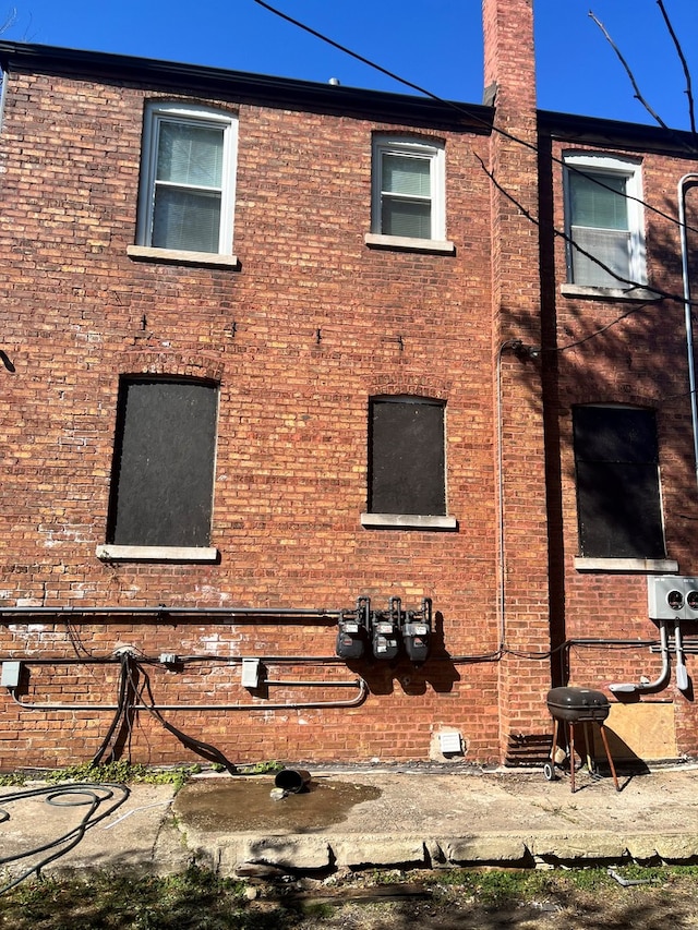 exterior space with a balcony and brick siding