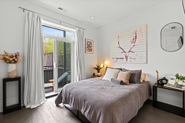 bedroom with access to outside, wood finished floors, and visible vents