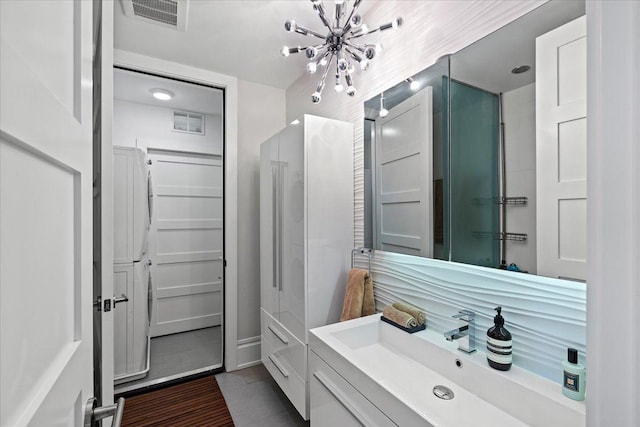 bathroom featuring vanity, visible vents, tile patterned flooring, and a chandelier