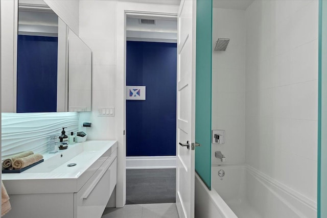 bathroom featuring shower / washtub combination, vanity, tile patterned flooring, and visible vents