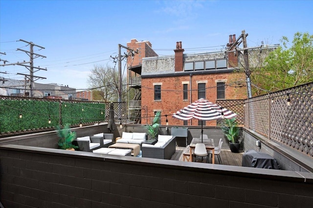 view of patio / terrace featuring area for grilling, fence, outdoor lounge area, and a balcony