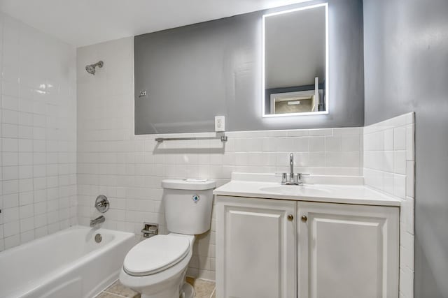 full bath featuring tile walls, toilet,  shower combination, and vanity
