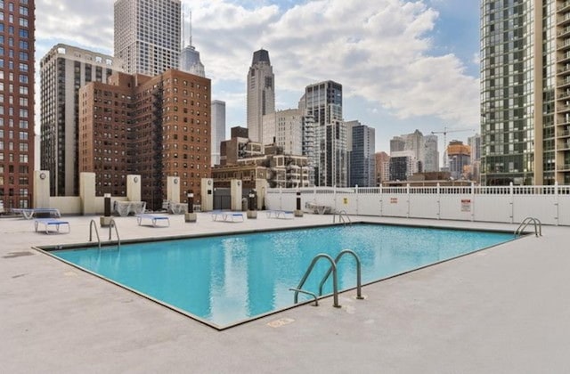 1122 N Clark St Unit 3501, Chicago, IL 60610 - pool featuring a view of city, fence, and a patio area
