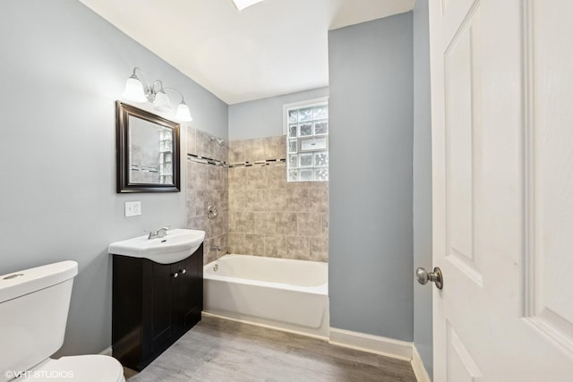 509 W 81st St, Chicago, IL 60620 - bathroom featuring wood finished floors, toilet, shower / bath combination, vanity, and baseboards