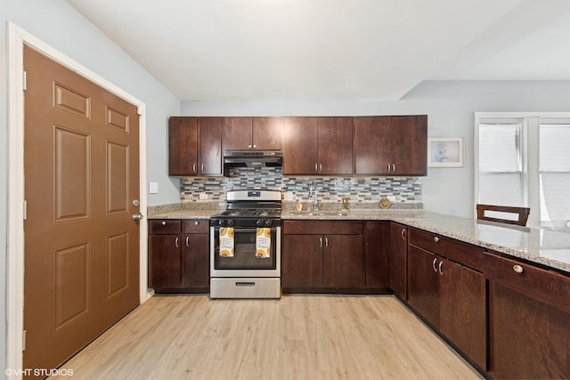 509 W 81st St, Chicago, IL 60620 - kitchen with gas stove, under cabinet range hood, light wood-style floors, and decorative backsplash