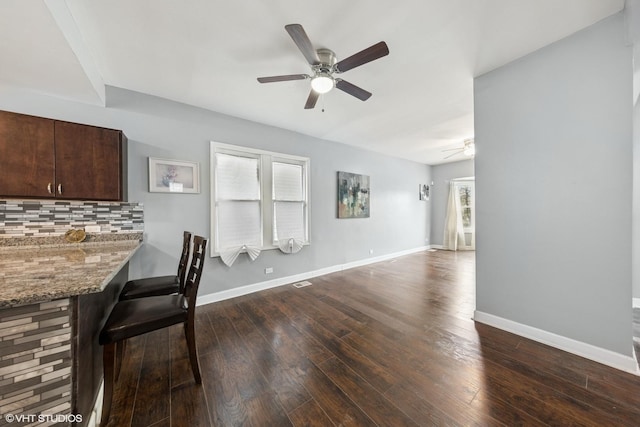 509 W 81st St, Chicago, IL 60620 - unfurnished dining area featuring a ceiling fan, dark wood-type flooring, and baseboards