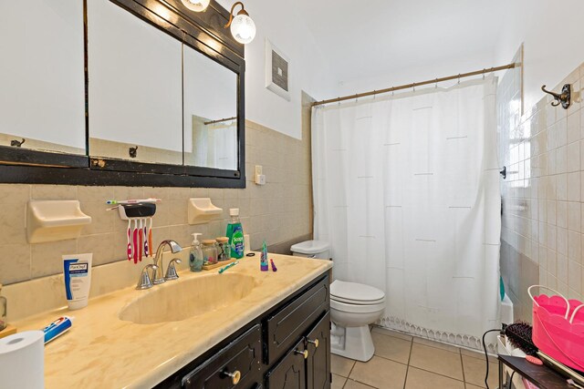 full bathroom featuring visible vents, toilet, tile walls, vanity, and tile patterned flooring