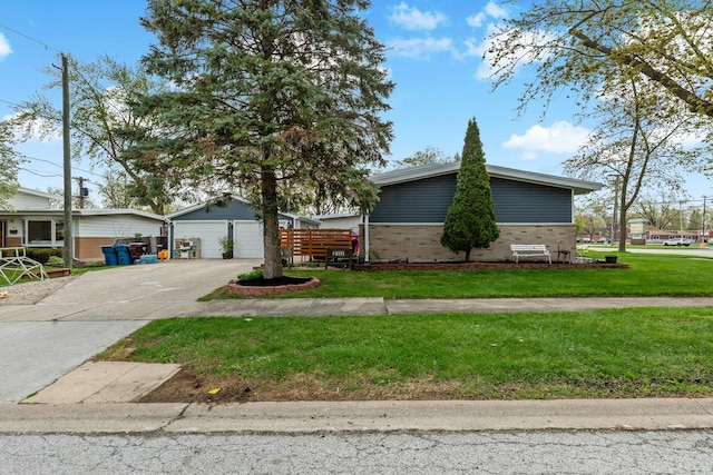 mid-century home with a front yard, brick siding, and an outbuilding