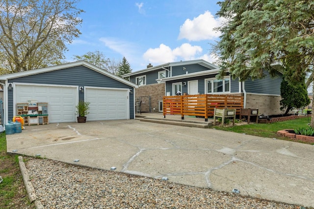 view of front of property with an outdoor structure, brick siding, and a garage