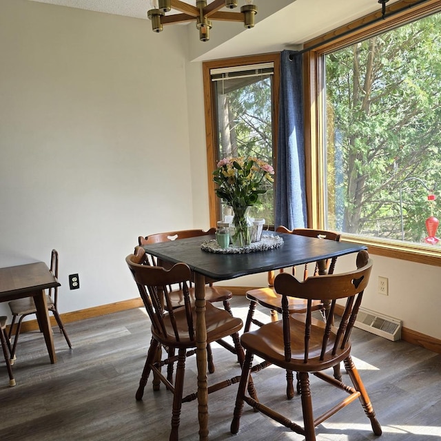 dining space with dark wood finished floors and baseboards