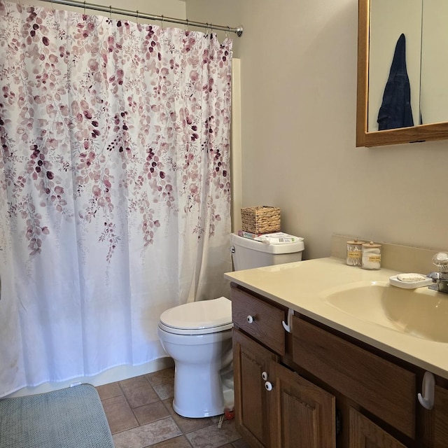 full bathroom with toilet and vanity