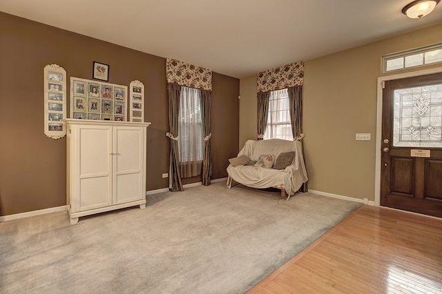 foyer entrance with baseboards and wood finished floors