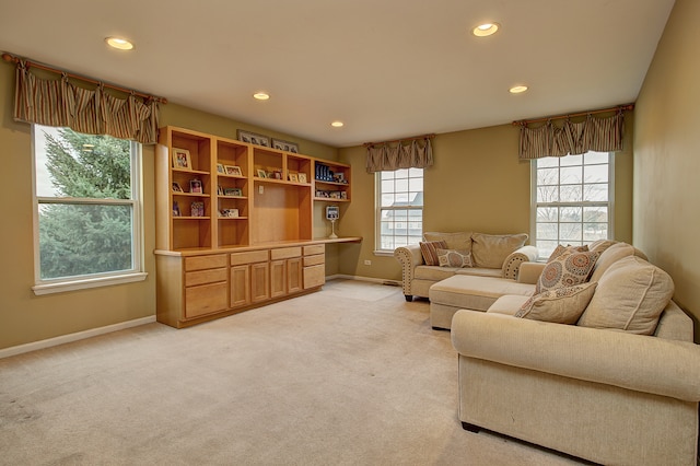 living room with light colored carpet, recessed lighting, and baseboards