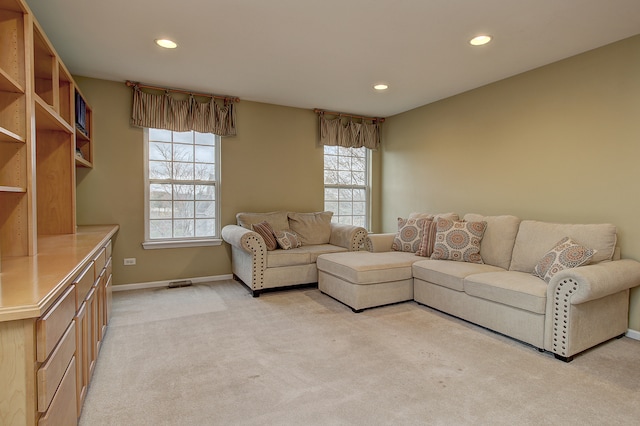 living room with light colored carpet, plenty of natural light, and recessed lighting