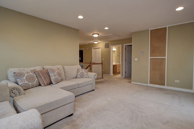 living area featuring visible vents, baseboards, attic access, recessed lighting, and light carpet