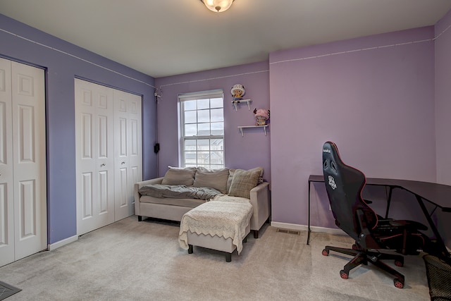 carpeted office with visible vents and baseboards