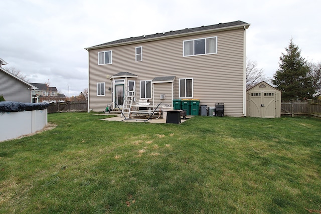 back of property with a patio area, an outbuilding, a fenced backyard, a storage shed, and a lawn
