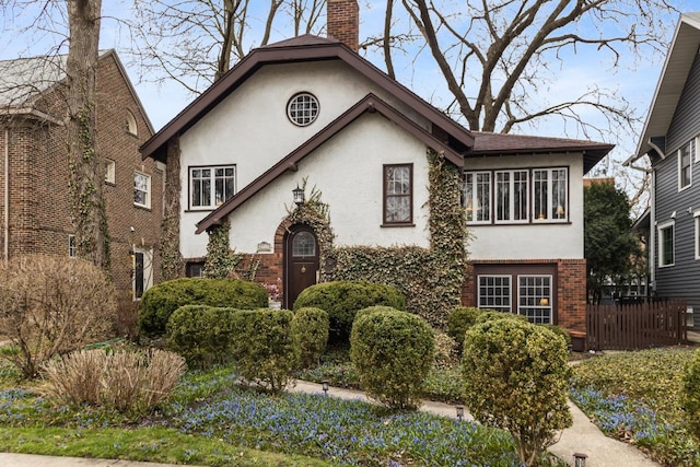 2717 Harrison St, Evanston, IL 60201 - view of front of home with a chimney, brick siding, and stucco siding