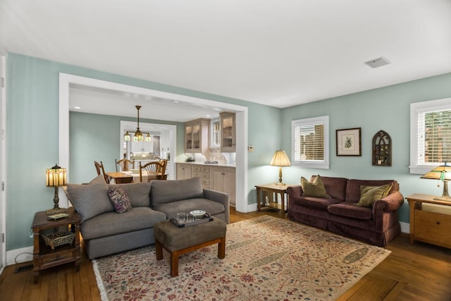 2717 Harrison St, Evanston, IL 60201 - living room with dark wood-style flooring, a chandelier, and baseboards