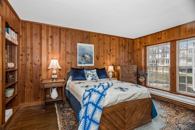 2717 Harrison St, Evanston, IL 60201 - bedroom with wood walls, dark wood-type flooring, and baseboards