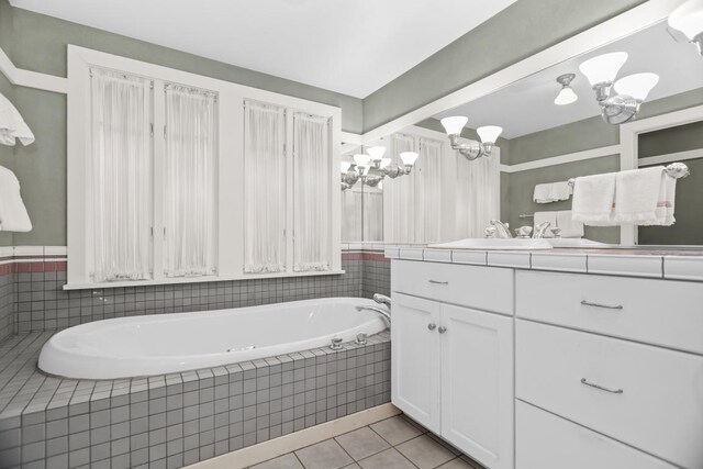 2717 Harrison St, Evanston, IL 60201 - full bathroom featuring a chandelier, tile patterned floors, a garden tub, and vanity