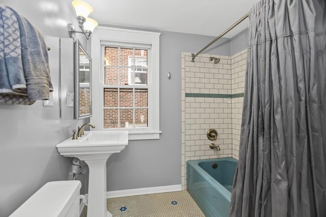 2717 Harrison St, Evanston, IL 60201 - bathroom featuring toilet, shower / bath combo, tile patterned flooring, and baseboards