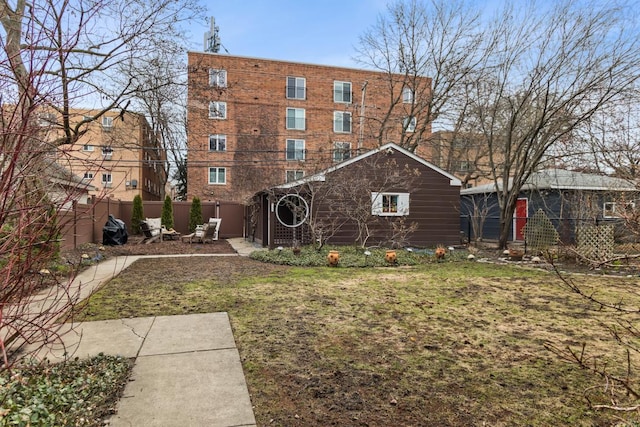 2717 Harrison St, Evanston, IL 60201 - rear view of property featuring fence and a yard