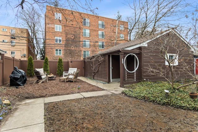 2717 Harrison St, Evanston, IL 60201 - view of front of house featuring an outdoor fire pit, fence, and an outdoor structure