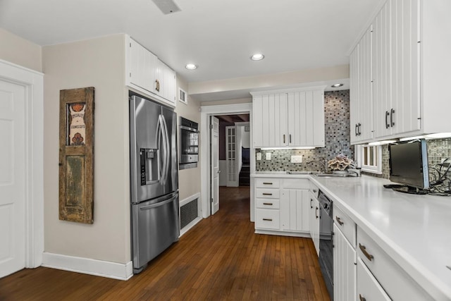 2717 Harrison St, Evanston, IL 60201 - kitchen with stainless steel appliances, light countertops, baseboards, recessed lighting, and dark wood-type flooring
