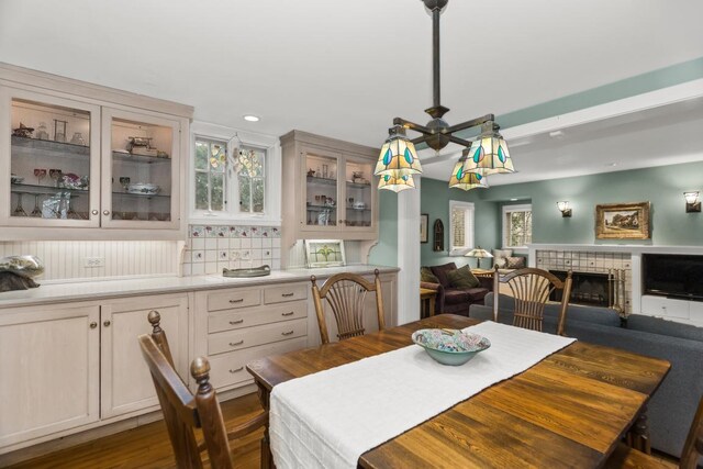 2717 Harrison St, Evanston, IL 60201 - dining space featuring dark wood-style floors, recessed lighting, ceiling fan, and a tiled fireplace