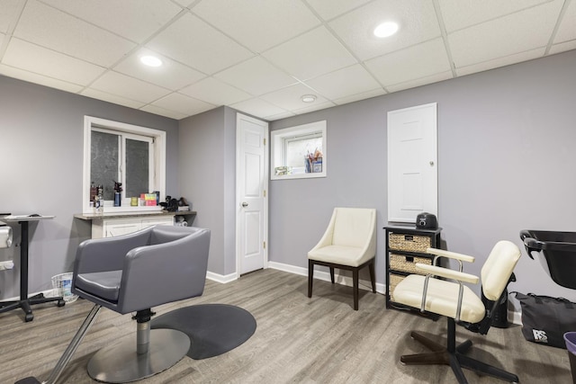 office space featuring wood finished floors, baseboards, a paneled ceiling, and recessed lighting