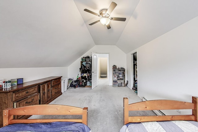 carpeted bedroom with a ceiling fan and lofted ceiling