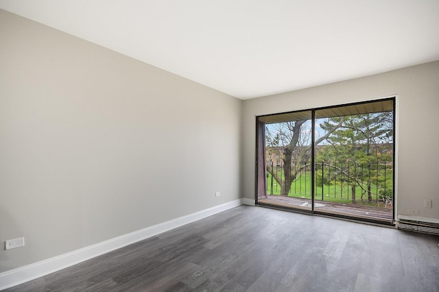 unfurnished room featuring dark wood-style flooring and baseboards