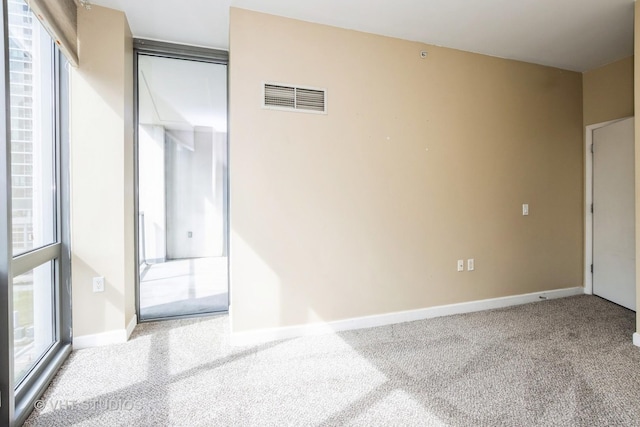 carpeted empty room with baseboards