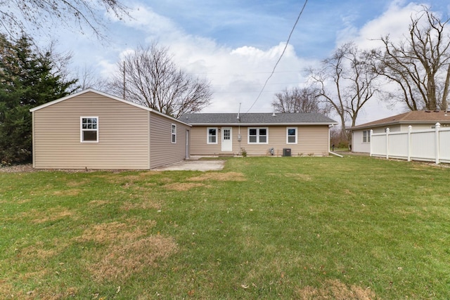back of house featuring a lawn, fence, cooling unit, and a patio