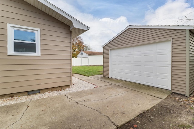 detached garage featuring concrete driveway