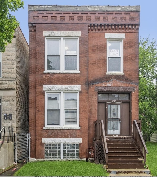 6618 S Marquette Rd, Chicago, IL 60637 - view of front of house featuring brick siding and a gate