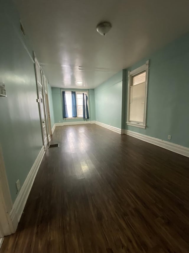 6618 S Marquette Rd, Chicago, IL 60637 - spare room featuring dark wood-type flooring and baseboards