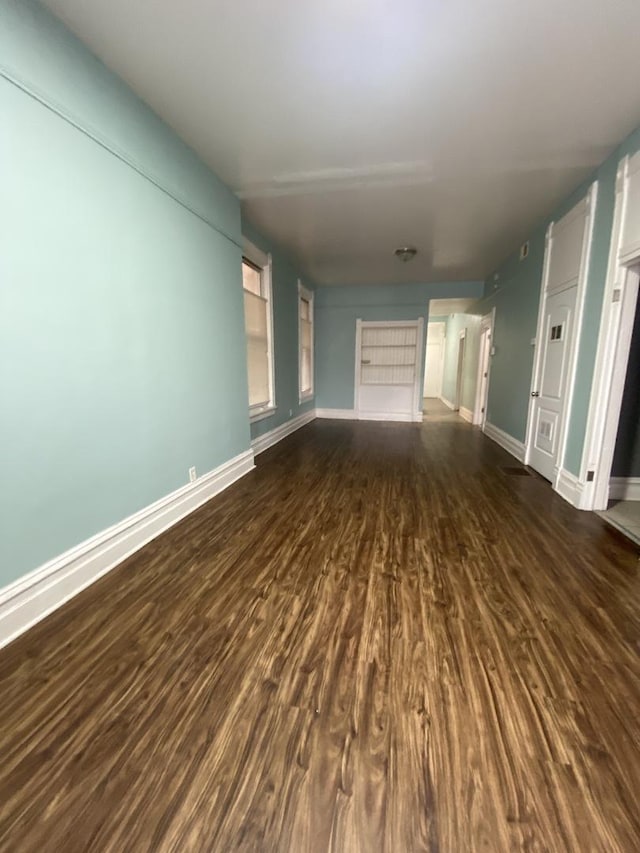 6618 S Marquette Rd, Chicago, IL 60637 - unfurnished living room featuring dark wood-type flooring and baseboards