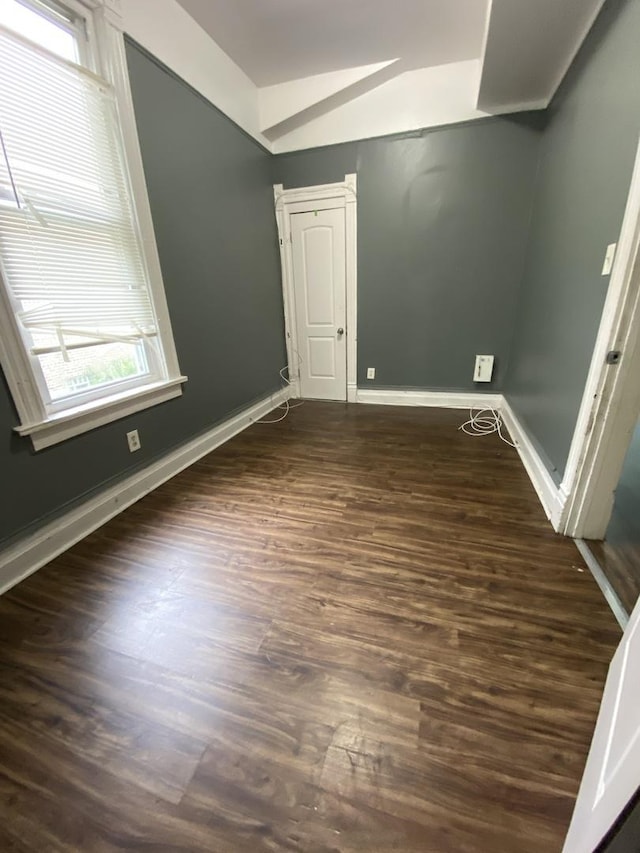 6618 S Marquette Rd, Chicago, IL 60637 - empty room featuring lofted ceiling, dark wood-type flooring, and baseboards