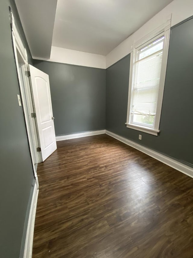 6618 S Marquette Rd, Chicago, IL 60637 - unfurnished room featuring baseboards and dark wood-style floors