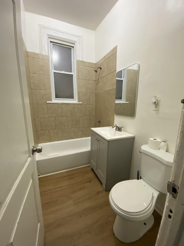 6618 S Marquette Rd, Chicago, IL 60637 - full bath with toilet, vanity, shower / bathtub combination, and wood finished floors