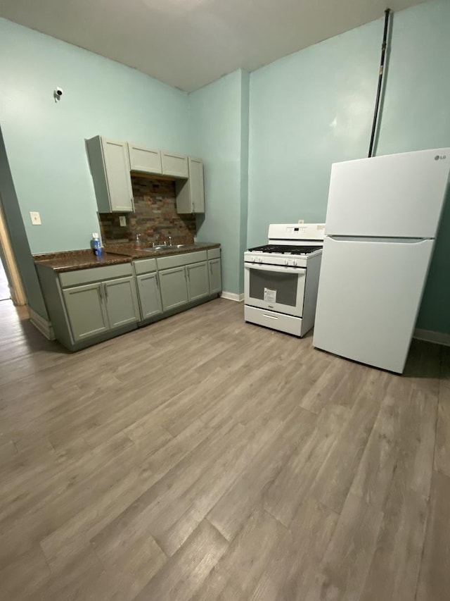 6618 S Marquette Rd, Chicago, IL 60637 - kitchen featuring white appliances, baseboards, backsplash, and light wood finished floors