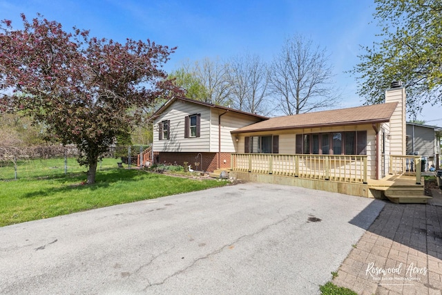 510 W 3rd St, Braidwood, IL 60408 - tri-level home with a deck, a chimney, and a front lawn